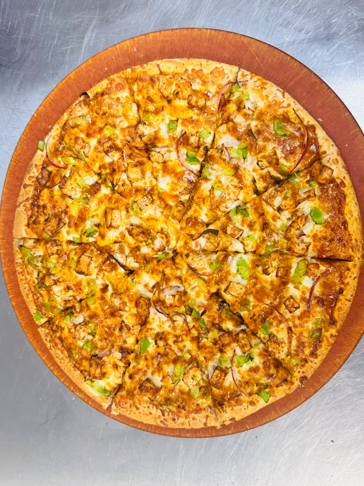 Freshly made pizza with cheese and assorted toppings from Jomaa's Capilano